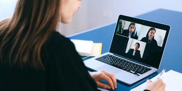 An employee enjoying a video call with her work colleagues